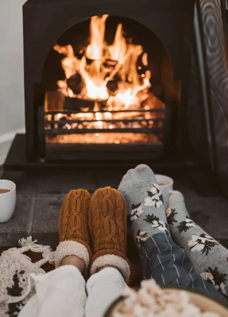 Cozy feet with socks chilling by the fire