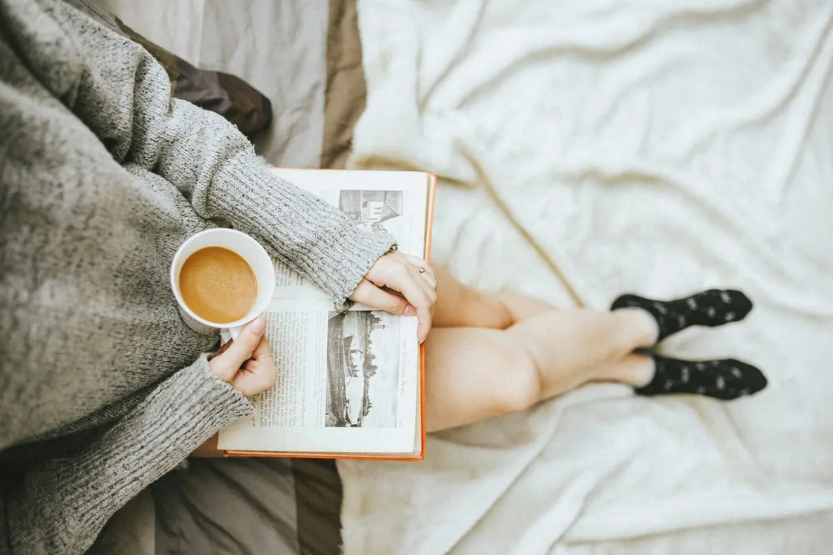 Incorporate relaxation — cozy self-care time with a book and coffee