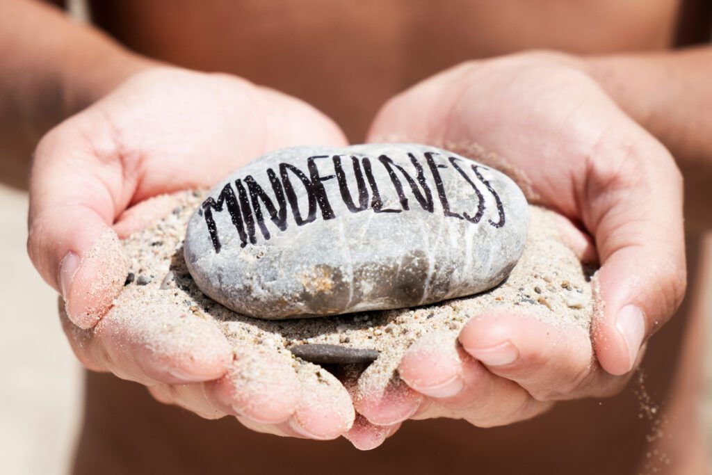 Person-holding-rock-with-Mindfulness-written-on-it